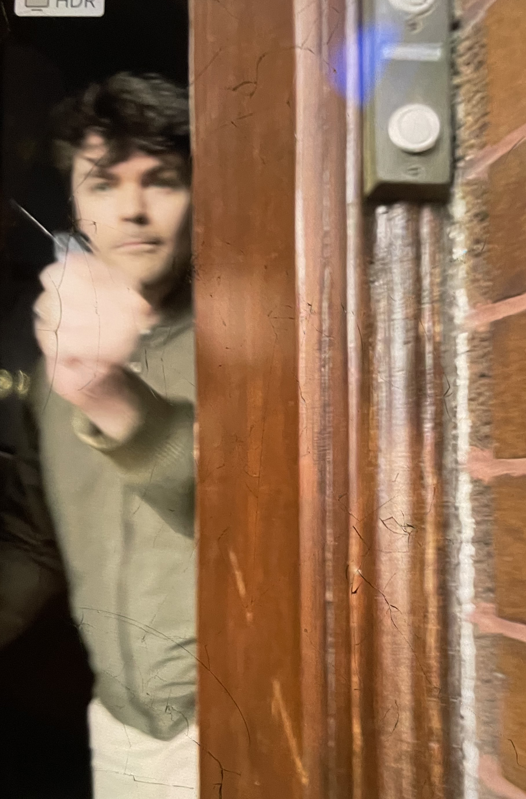In a still from video, far-right streamer Nick Fuentes appears to pepper-spray Marla Rose out his door in Berwyn on Sunday. (Marla Rose)