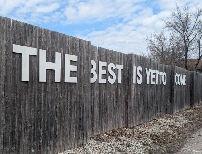 The words "The Best is Yet to Come" have been placed on a fence in downtown East Dundee where the village's newest mural is to be painted on July 26. (Village of East Dundee)