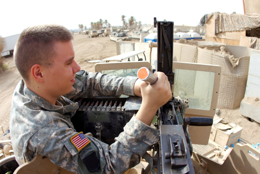 U.S. Soldier performs maintenance on a Browning .50 Cal Heavy-Barrel machine gun