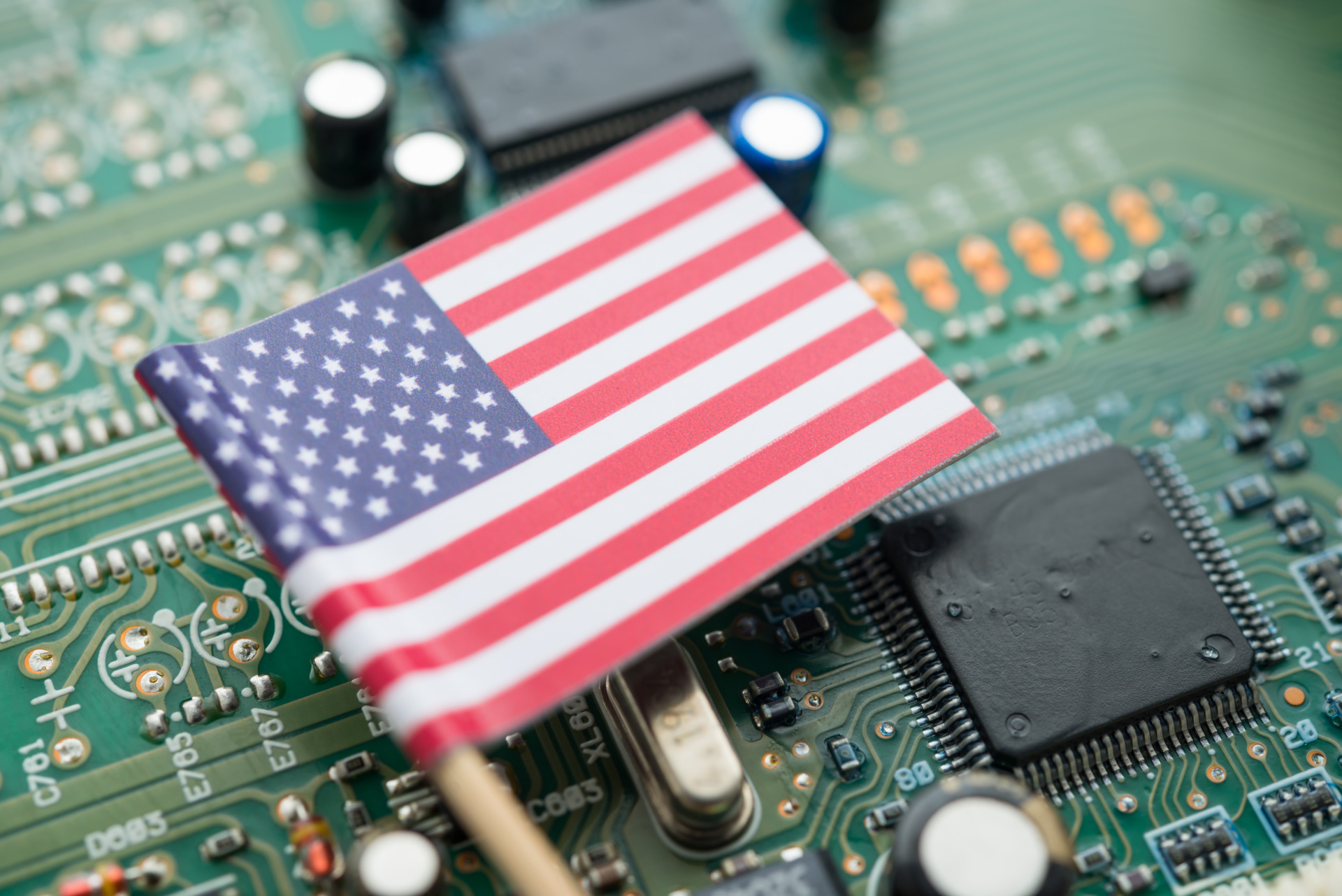 A U.S. flag on a green circuit board background
